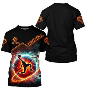 T-shirt basketball galactique noir et orange avec joueur dunk cosmos flammes et constellations