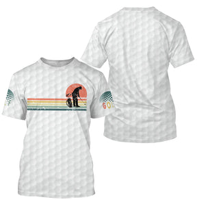 T-shirt golf vintage blanc avec design golfeur silhouette soleil orange dégradé et inscription GOLF